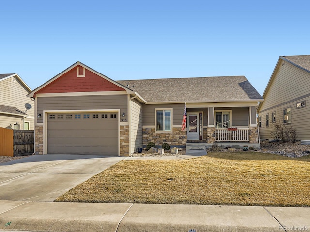 craftsman-style house featuring a porch, stone siding, driveway, and an attached garage