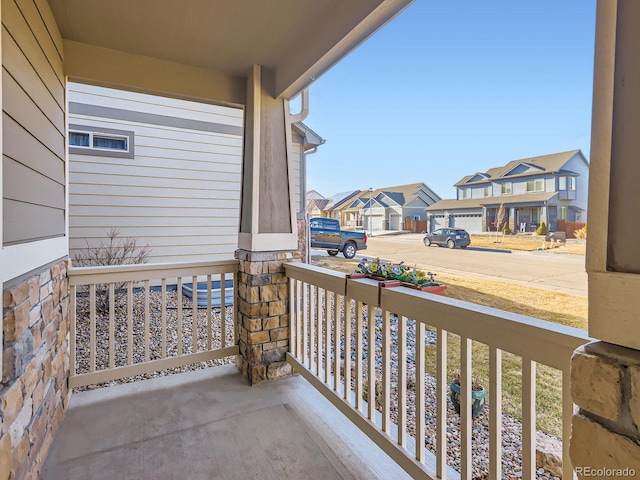 balcony with covered porch and a residential view