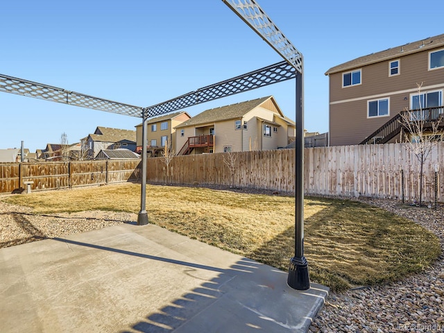 view of patio / terrace featuring a fenced backyard and a residential view