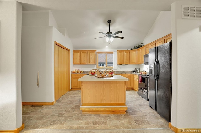 kitchen with a center island, light countertops, visible vents, ceiling fan, and black appliances