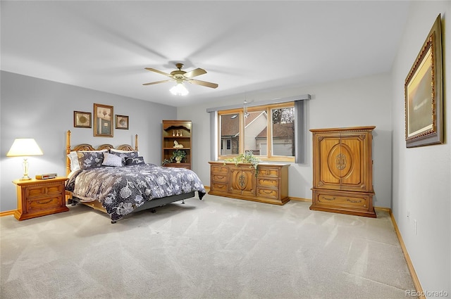 bedroom with light colored carpet, ceiling fan, and baseboards