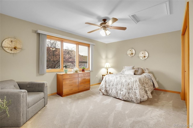 bedroom with attic access, baseboards, and light colored carpet