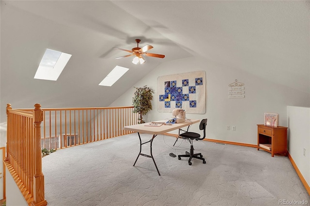 carpeted office space with lofted ceiling, ceiling fan, and baseboards