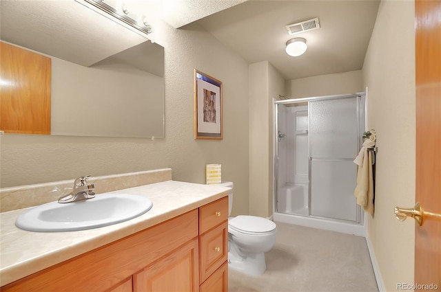 bathroom with toilet, a shower stall, visible vents, and vanity