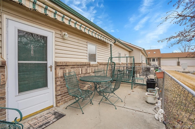 view of patio / terrace featuring outdoor dining space and fence