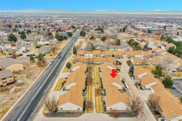 drone / aerial view featuring a residential view and a mountain view