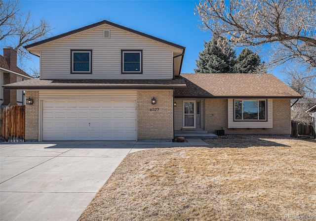 view of front of home featuring fence and brick siding