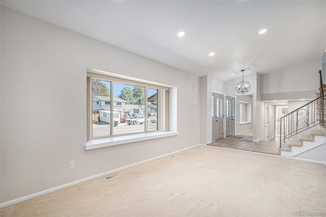 interior space with stairway, carpet flooring, baseboards, and a chandelier