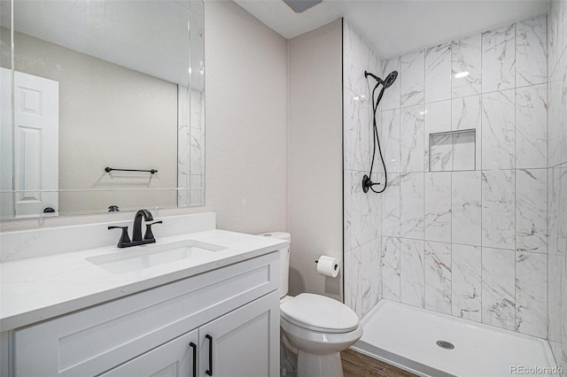 bathroom featuring vanity, toilet, and a stall shower