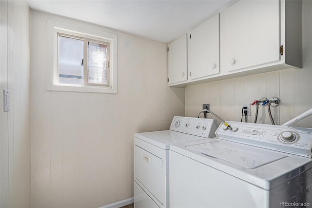 laundry room with cabinet space and separate washer and dryer