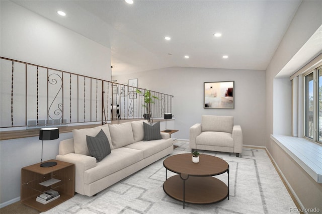 living room featuring recessed lighting, baseboards, and vaulted ceiling