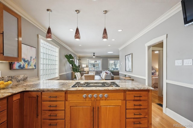 kitchen featuring crown molding, stainless steel gas stovetop, brown cabinetry, light wood-type flooring, and a peninsula