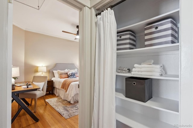 bedroom featuring crown molding and wood finished floors