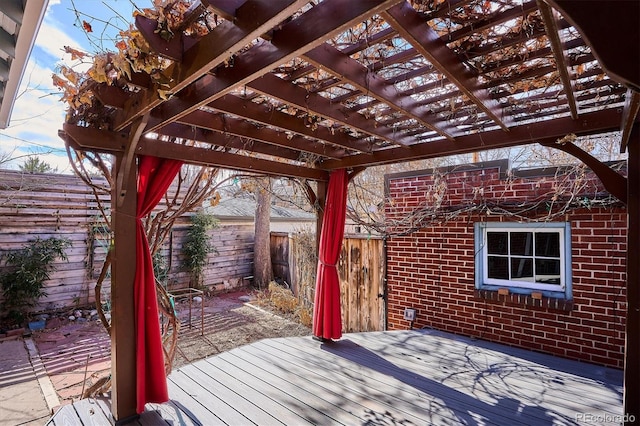 deck featuring a fenced backyard and a pergola