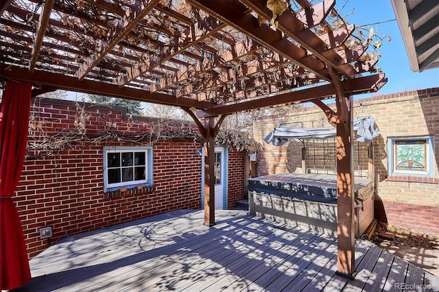 wooden terrace featuring a pergola and a hot tub