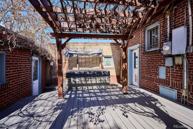 deck with a hot tub, a grill, and a pergola