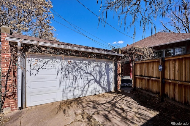 detached garage featuring fence