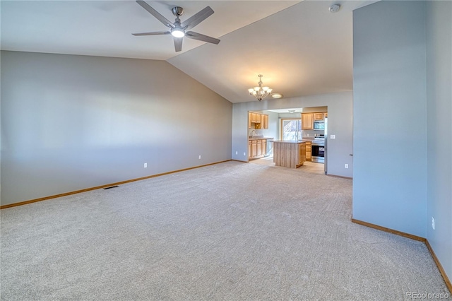 unfurnished living room featuring lofted ceiling, light carpet, sink, and ceiling fan with notable chandelier