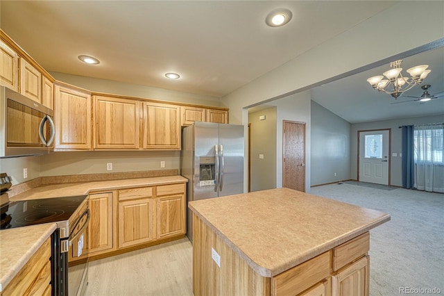 kitchen with decorative light fixtures, a kitchen island, stainless steel appliances, light brown cabinetry, and ceiling fan with notable chandelier