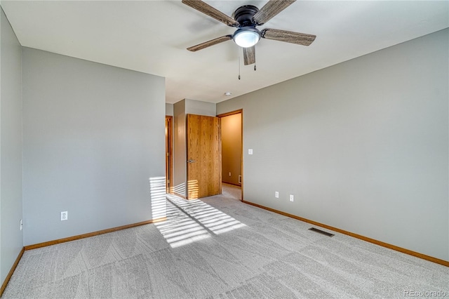 interior space featuring light carpet and ceiling fan