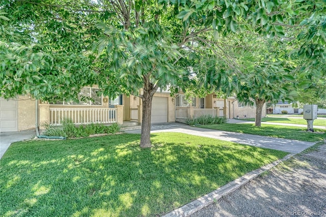 obstructed view of property with a front lawn, a porch, and a garage