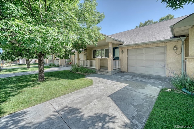 view of front of home featuring a garage, a front lawn, and covered porch