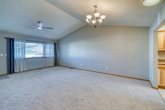 carpeted spare room with lofted ceiling and ceiling fan with notable chandelier