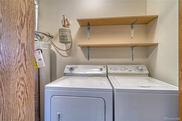 laundry area with washer and dryer and water heater