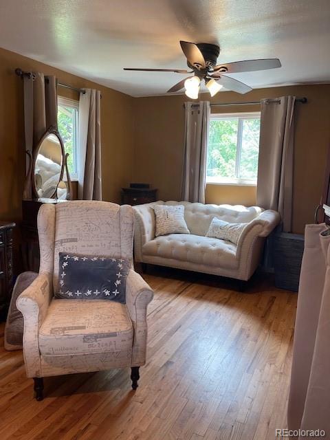 1473 S Monaco Pkwy S, Denver, CO 80224 - living area with a ceiling fan and wood finished floors