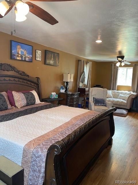 1473 S Monaco Pkwy S, Denver, CO 80224 - bedroom featuring wood finished floors and ceiling fan