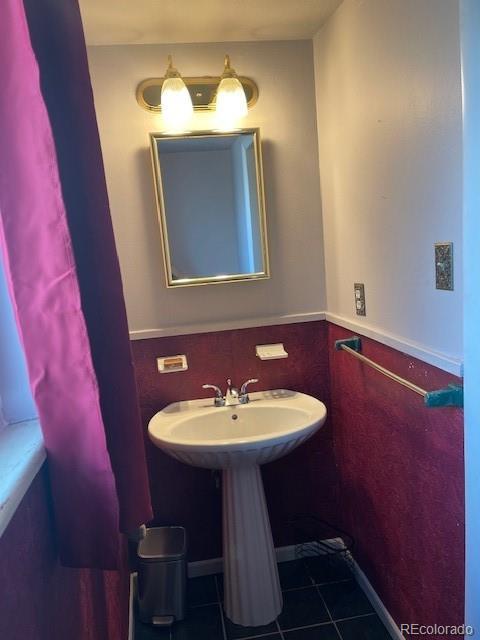 1473 S Monaco Pkwy S, Denver, CO 80224 - bathroom with tile patterned floors and a sink