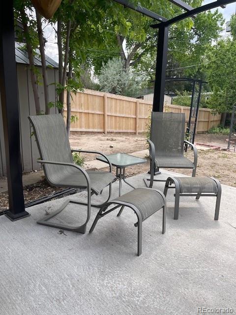 1473 S Monaco Pkwy S, Denver, CO 80224 - fenced backyard featuring a patio area
