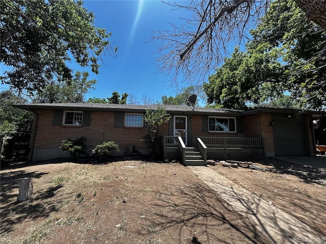 8319 Quivas Way, Denver, CO 80221 - ranch-style home featuring brick siding, a garage, and driveway