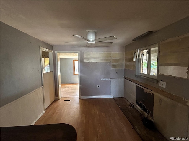 8319 Quivas Way, Denver, CO 80221 - spare room with ceiling fan, wood finished floors, and a wainscoted wall