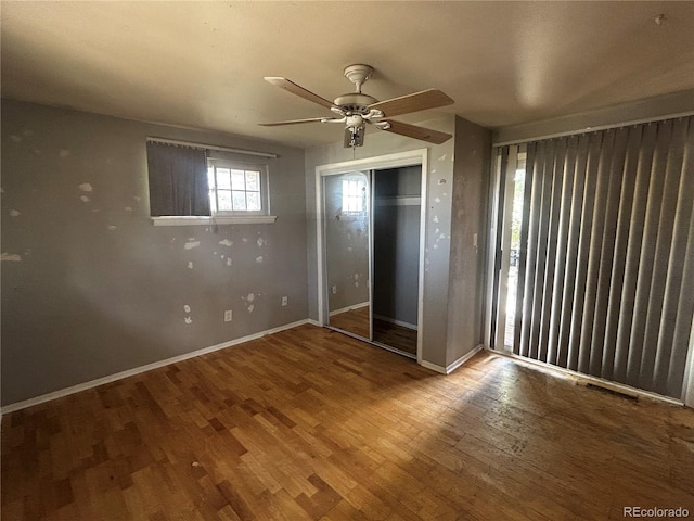 8319 Quivas Way, Denver, CO 80221 - unfurnished bedroom with wood finished floors, a closet, and a ceiling fan