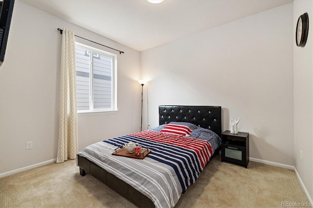 bedroom featuring carpet floors and baseboards