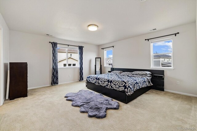 bedroom featuring visible vents, carpet, and baseboards