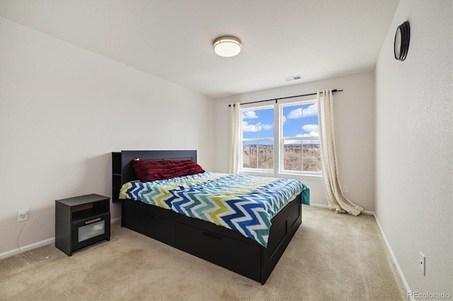 bedroom featuring baseboards, visible vents, and light carpet