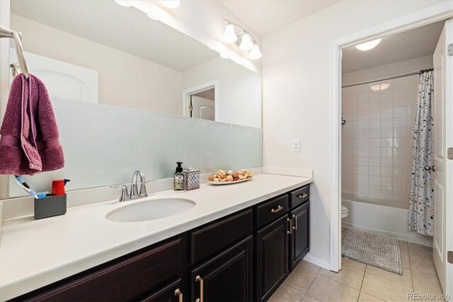full bathroom featuring vanity, tile patterned flooring, toilet, and shower / tub combo