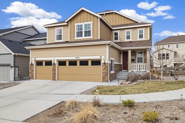 10913 Ledges Rd, Parker, CO 80134 - craftsman-style house featuring covered porch, a garage, driveway, board and batten siding, and stone siding