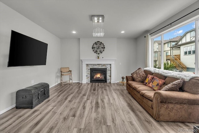 10913 Ledges Rd, Parker, CO 80134 - living area with wood finished floors, a stone fireplace, and recessed lighting