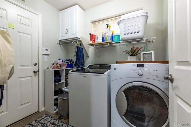 washroom featuring independent washer and dryer, tile patterned floors, and cabinet space
