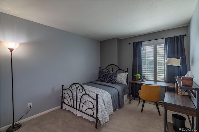 carpeted bedroom featuring baseboards