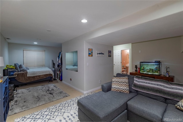 bedroom with ensuite bath, baseboards, recessed lighting, and light colored carpet