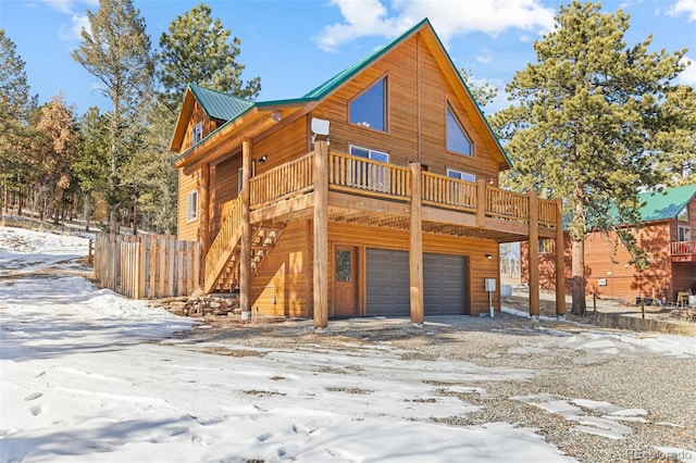 view of front of home featuring a garage and a deck