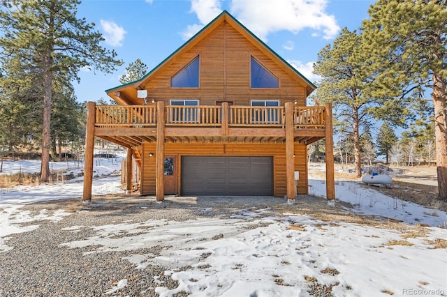 cabin with a garage and a deck