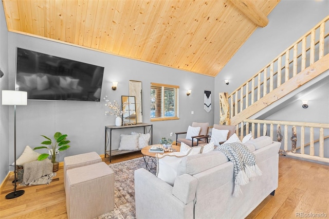 living room featuring beamed ceiling, high vaulted ceiling, wood ceiling, and light hardwood / wood-style flooring