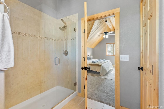 bathroom with lofted ceiling, a shower with door, and tile patterned floors