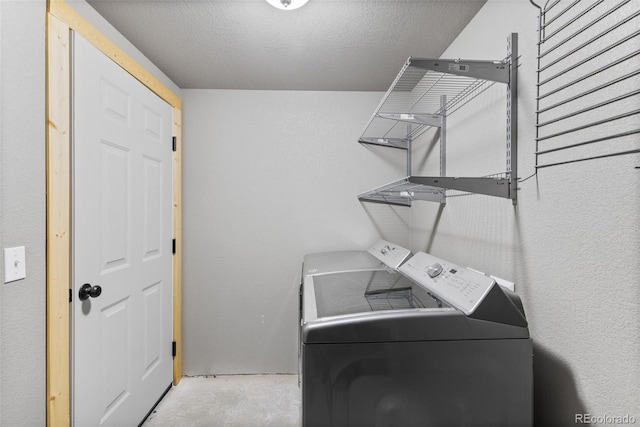 washroom featuring independent washer and dryer and a textured ceiling