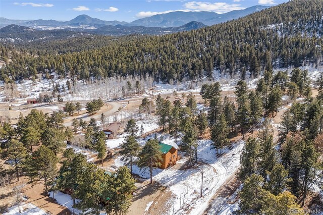 snowy aerial view with a mountain view